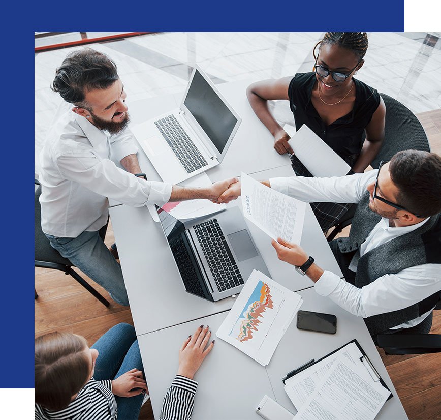 Accounts and customers sitting around a table looking at documents, handshake with customer and accountant